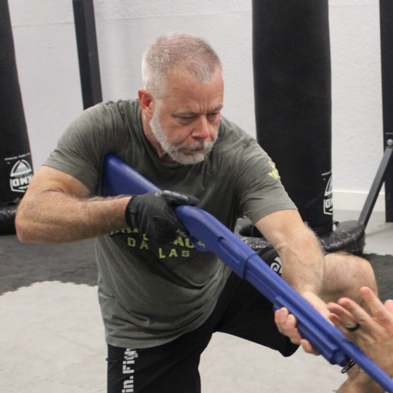 Coach Karl Owens training logingun defenses in class.